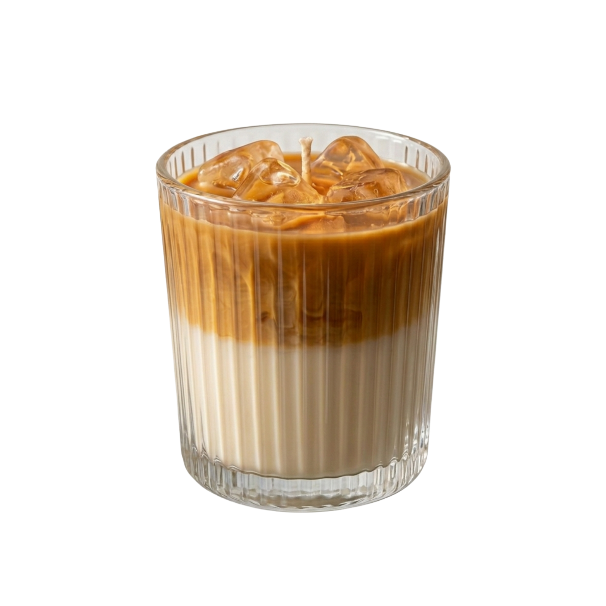 An iced coffee-flavored candle in a clear ribbed glass tumbler, filled with a layered brown and cream liquid and topped with ice cubes, on a solid white background.
