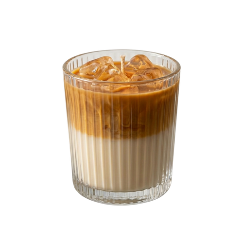 An iced coffee-flavored candle in a clear ribbed glass tumbler, filled with a layered brown and cream liquid and topped with ice cubes, on a solid white background.